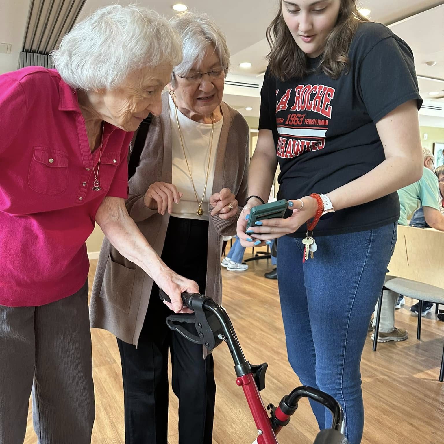 Student helping resident with smart phone